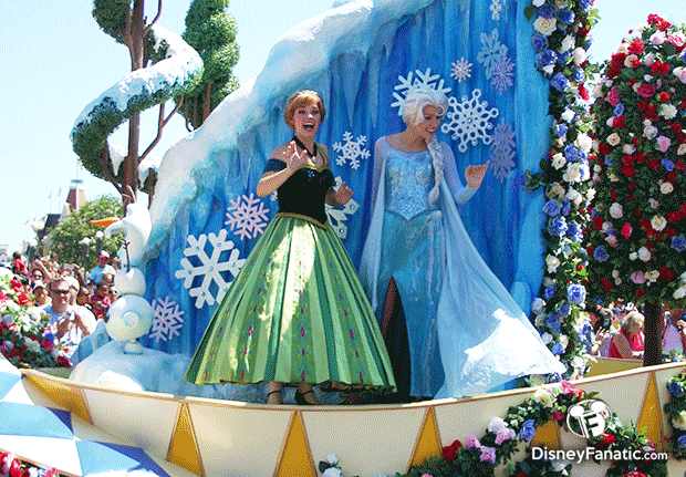 Anna And Elsa from Frozen wave at onlookers during the Festival of Fantasy Parade