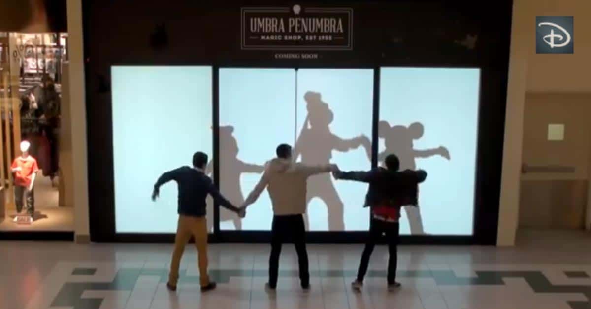 Guests in a mall interact with a giant screen, recreating iconic Disney character shadows in true Disney Parks style.