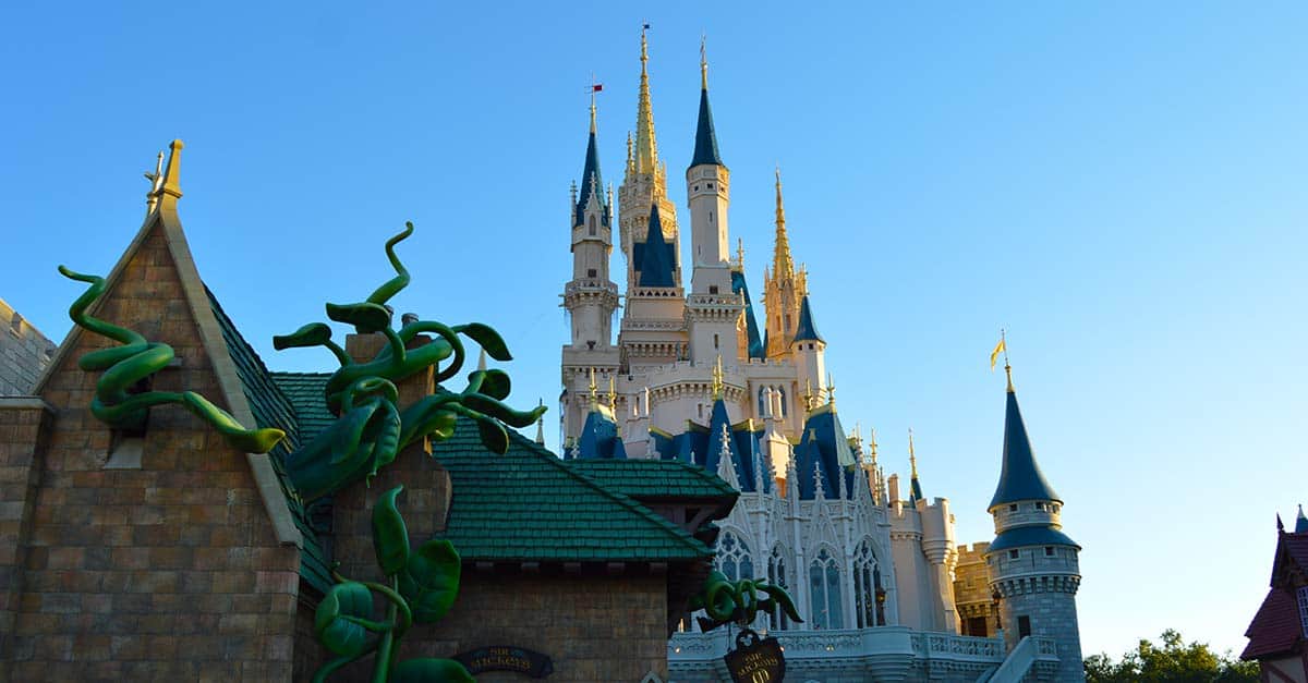 Cinderella Castle with soaring spires beside towering green beanstalks—an iconic Disney World scene for first-timers.
