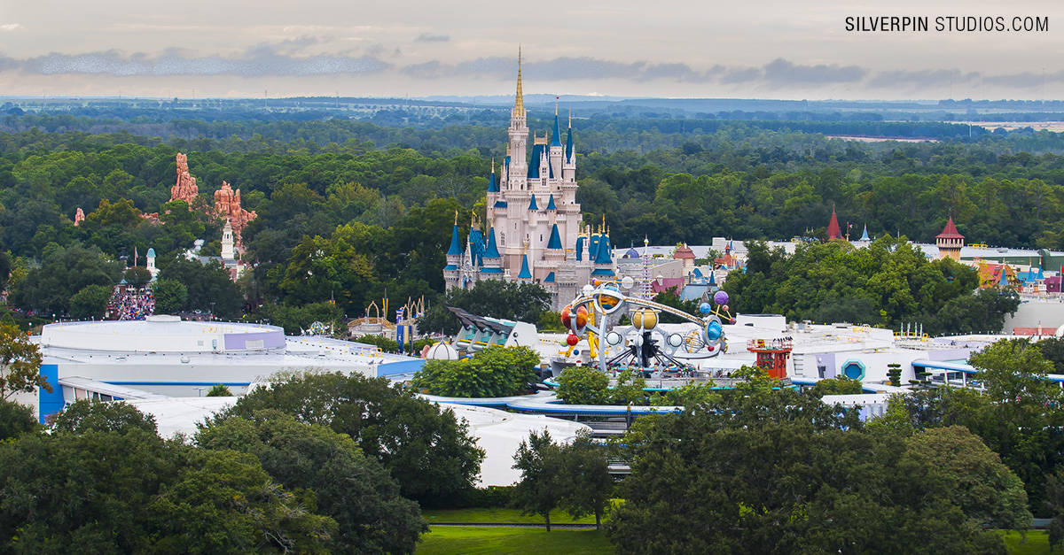 Bird’s-eye view of Magic Kingdom with Cinderella Castle, vibrant attractions, and lush trees—the perfect spot for a magical escape.