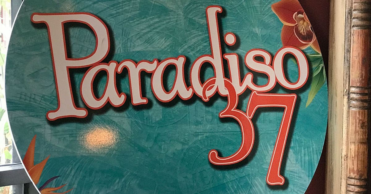 Paradiso 37 sign pops with tropical flair and teal colors, inviting guests at Disney Springs to a vibrant dining experience.