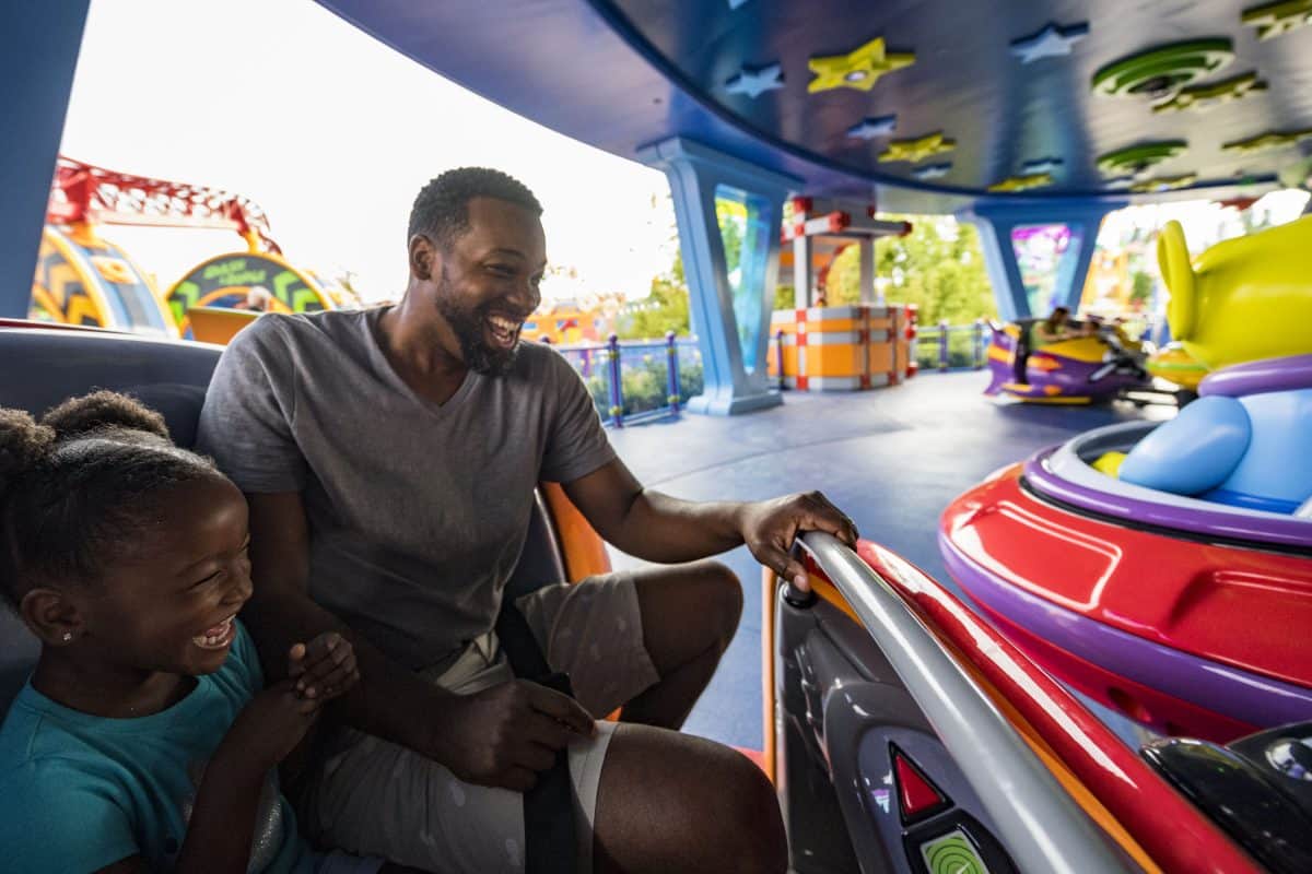 Guests of all ages share laughter and excitement while spinning on the vibrant teacup ride at Magic Kingdom.