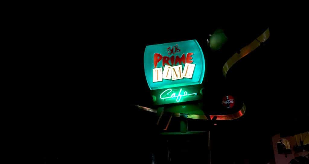 50’s Prime Time Café neon sign shines vividly at Disney's Hollywood Studios, setting a retro vibe visitors love after dark.