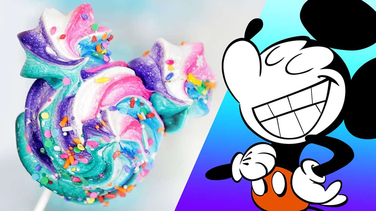 A vibrant Mickey Mouse meringue treat, inspired by Disney snacks, sits next to smiling Mickey on a cheerful blue backdrop.