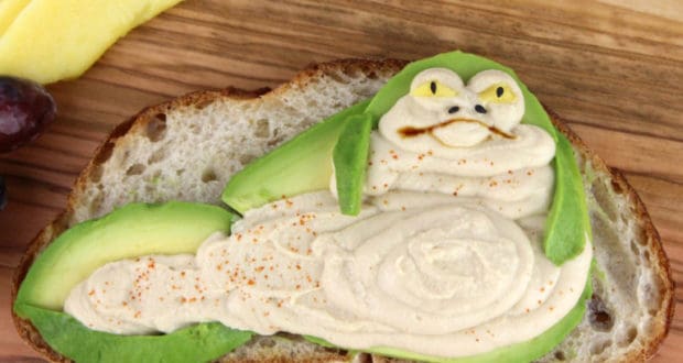 Jabbacado Toast: Hummus and avocado on bread creatively shaped like Jabba the Hutt, perfect for your Star Wars-themed feast!.