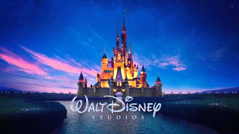 Disney castle aglow at twilight, Walt Disney Studios logo below, spotlighting Disney+ favorites like The One and Only Ivan.
