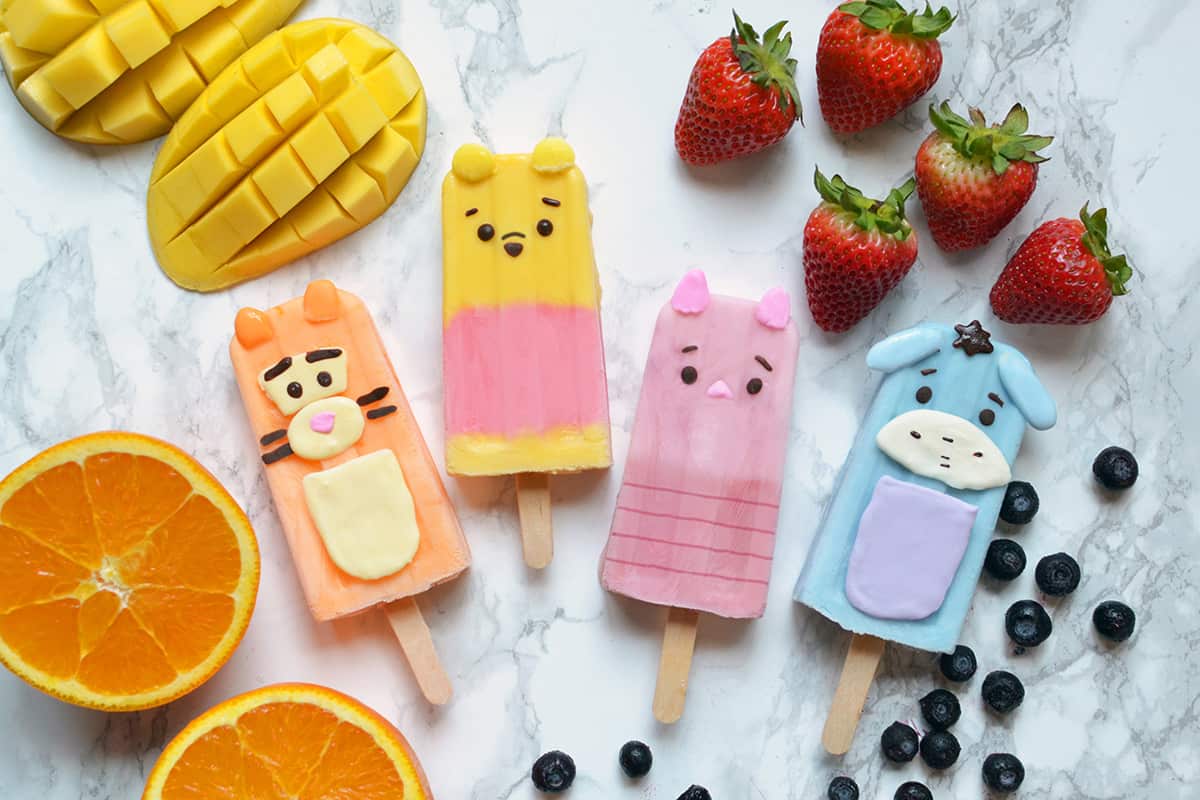 Winnie the Pooh-themed popsicles with fruit accents, perfect snacks for Disney Parks fans and character meet-and-greets.