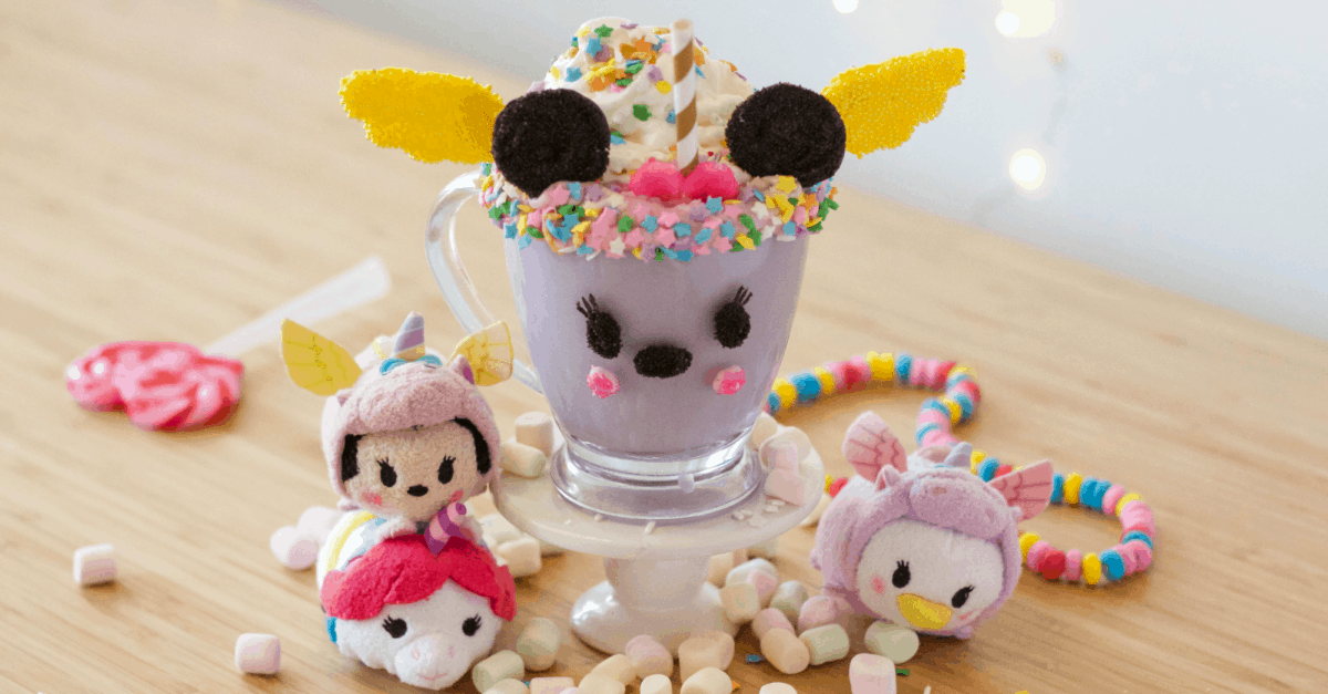 A whimsical purple milkshake topped with candy and plushies, evoking Unicorn Hot Cocoa magic at a theme park treat stand.