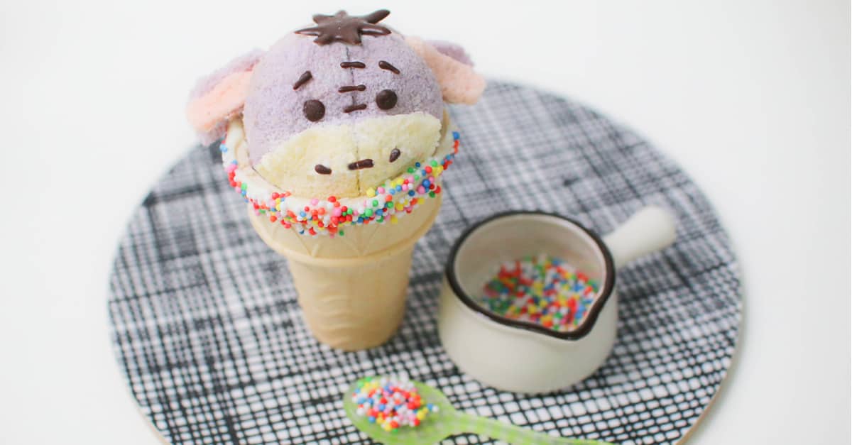 Treat yourself to an Eeyore cupcake cone—ice cream in a cone, decorated with colorful sprinkles and extra sprinkle fun at Disney Parks.