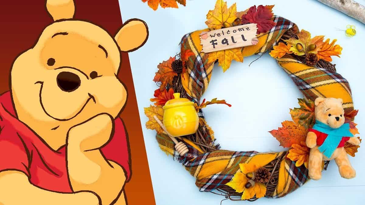 Winnie the Pooh's autumn wreath features fall leaves, a honey pot, and "Welcome Fall," perfect for Disney-inspired home decor.
