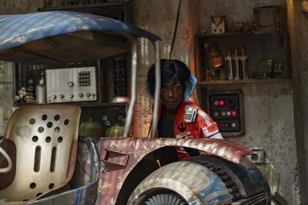 A guest pilots a weathered sci-fi speeder inside the immersive, industrial world of Star Wars: Galaxy’s Edge.