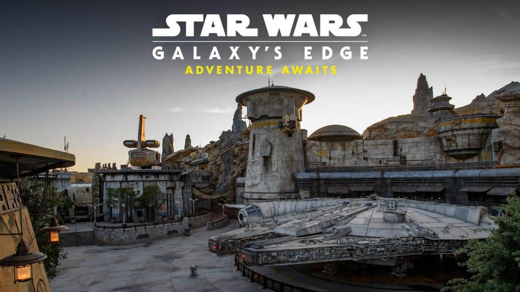The Millennium Falcon shines at Star Wars: Galaxy’s Edge, framed by alien rock formations and glowing futuristic Disney buildings at sunset.