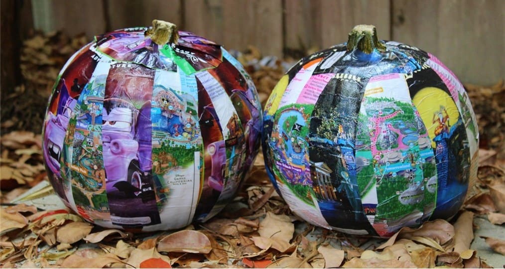 Pumpkins decked out with Disney park maps and magazines bring magical, theme park-inspired flair to this festive fall display.
