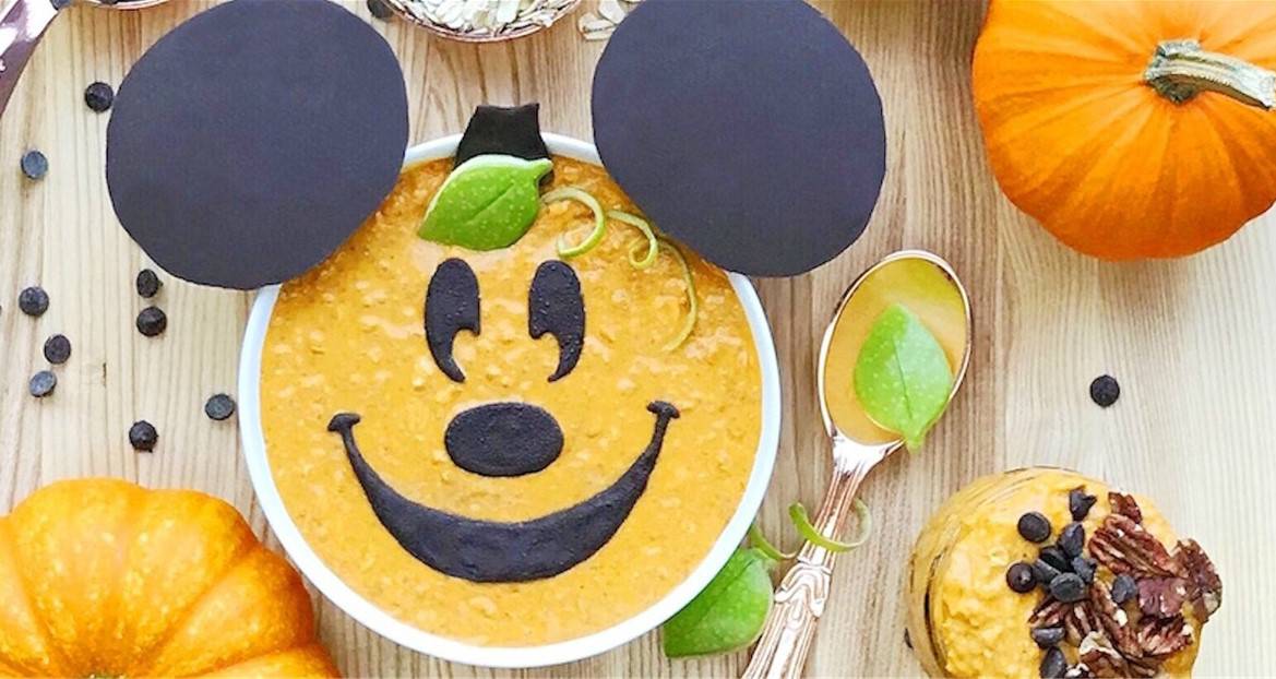 Pumpkin oatmeal styled like a cheerful Mickey Pumpkin Spice face with chocolate ears, surrounded by pumpkins for festive Disney vibes.