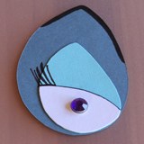 Ursula-inspired eye paper cutout with a purple gem center on a teardrop base—great for Disney Villains DIY at home or events.