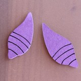 Ursula-inspired purple, tentacle-shaped pieces with black lines on wood—ideal for Disney Villains fans or Halloween at Disney Parks.