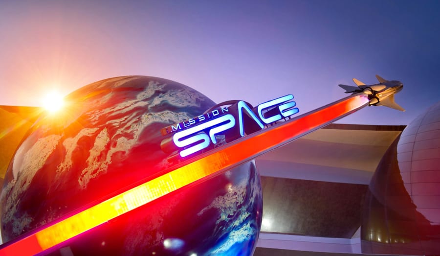 The Mission: SPACE entrance at EPCOT, featuring its signature globe, soaring jet, and vibrant red beam illuminated against a dramatic sunset sky—an unforgettable display capturing the thrilling spirit of Disney’s space-themed adventure.