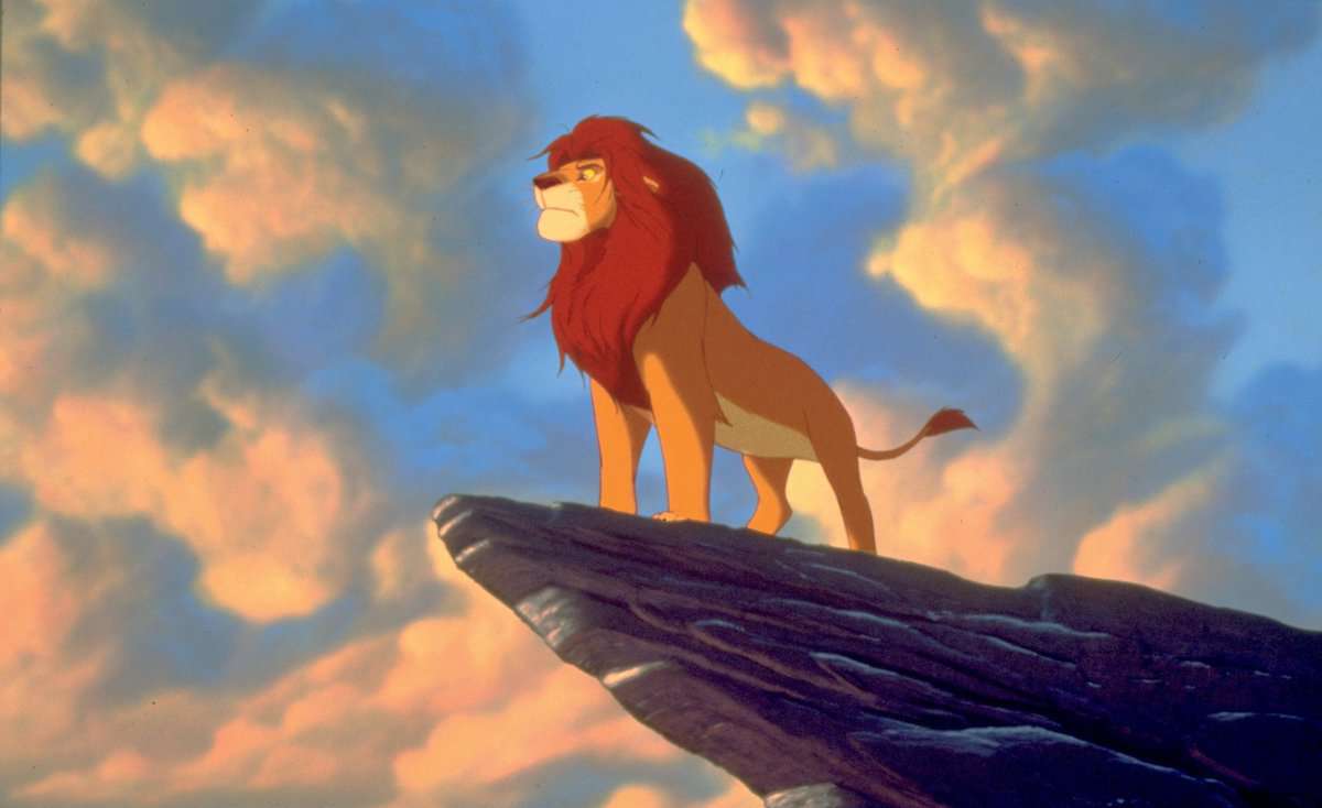 the lion king mufasa poses on pride rock