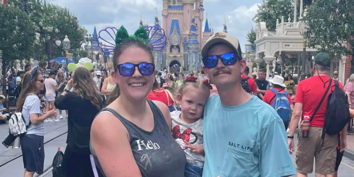 holly and cody with their daughter in disney world