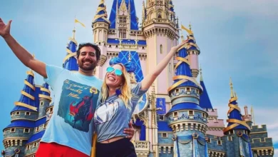 Disney Adults posing in front of cinderella's castle in magic kingdom