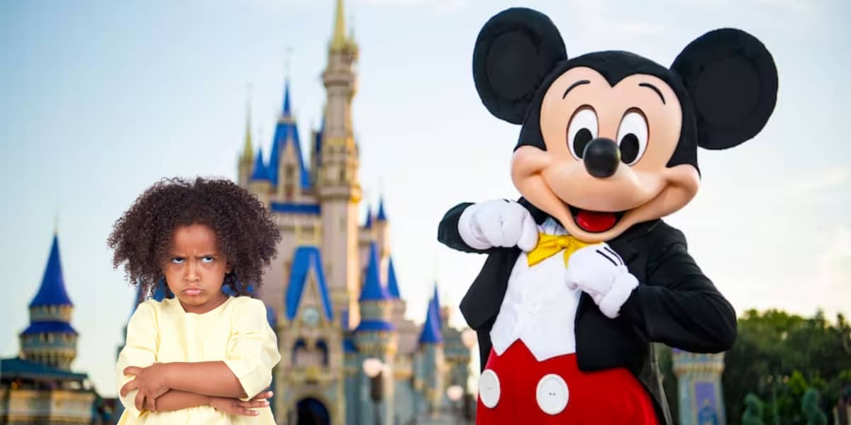 A child with curly hair stands with arms crossed, looking upset. Next to the child is a person dressed as a large mouse character wearing red shorts, a yellow bow tie, and white gloves. In the background, a whimsical castle with blue and gold accents evokes the enchantment of Disney Magical Express.