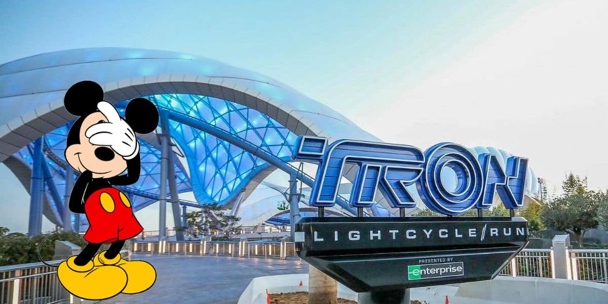 tron lightcycle run exterior at magic kingdom with mickey mouse doing a facepalm overlay