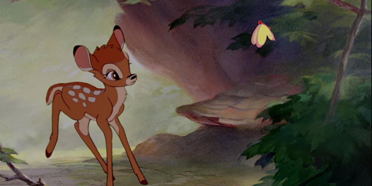 A young fawn with white spots, reminiscent of Bambi, stands inquisitively on a forest floor and looks up at a small yellow butterfly. The background features dense trees and foliage, creating a whimsical woodland scene.