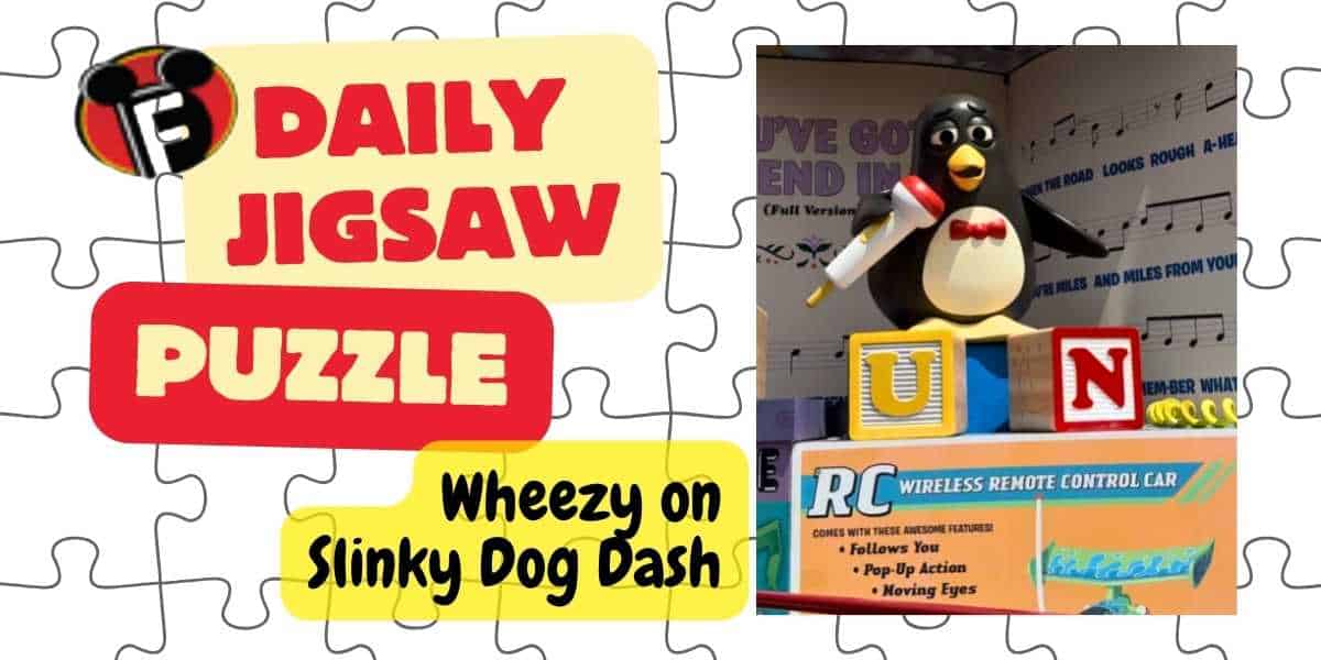 A jigsaw puzzle image featuring the text "DAILY JIGSAW PUZZLE" and "Wheezy on Slinky Dog Dash." A penguin character holding a microphone stands on stacked alphabet blocks. Nearby text promotes an RC wireless remote control car and music notes are in the background.