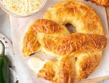 Melted cheese coming out of a Jalapeno Cheese Stuffed Pretzel.