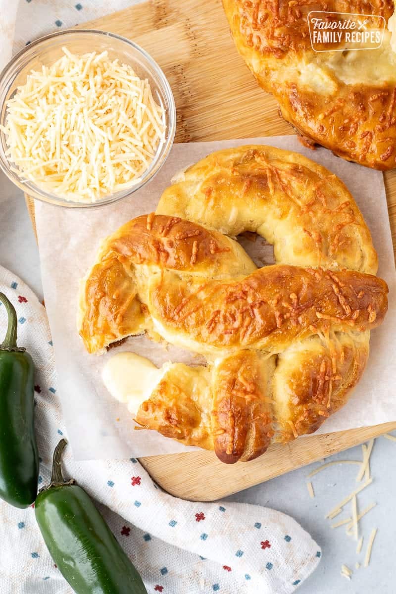 The jalapeno cheese stuffed pretzel is one of my very favorite treats at Disneyland. Now you can have this spicy, cheesy taste of Disney at home! Melted cheese coming out of a Jalapeno Cheese Stuffed Pretzel.