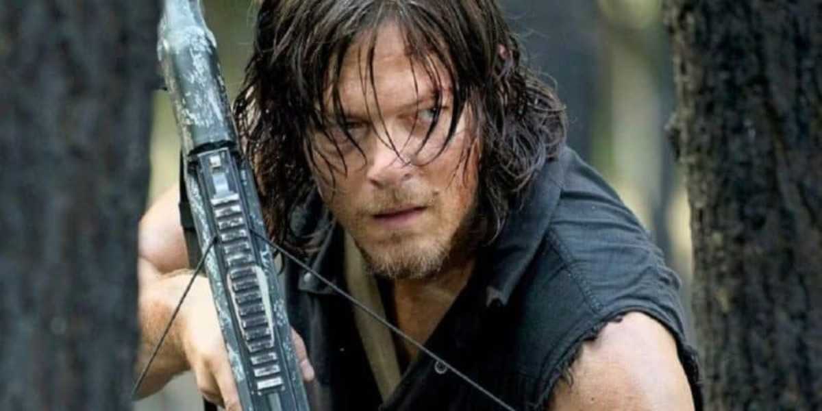 A person with long hair and a rugged appearance intently aims a crossbow. They are wearing a sleeveless black shirt and are surrounded by a forest, indicating a tense and focused situation in an outdoor, possibly survival scenario.