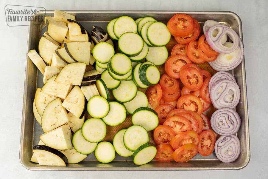 Ratatouille is the best way to enjoy fresh summer vegetables. This dish is delicious, healthy, and packed with flavor. Sliced eggplant, zucchini, tomatoes, and red onion.