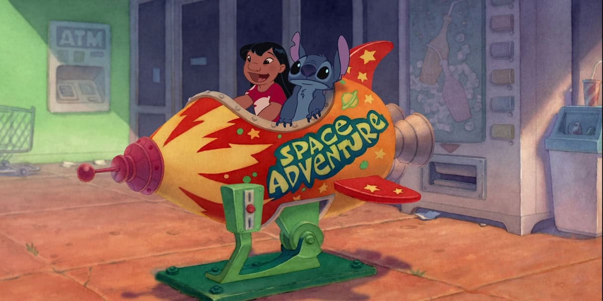 A cartoon girl and a blue alien sit in a rocket-themed amusement ride labeled "Space Adventure." The ride features bright flames and stars. They appear joyful. In the background, there's an ATM, empty shopping cart, and vending machine.