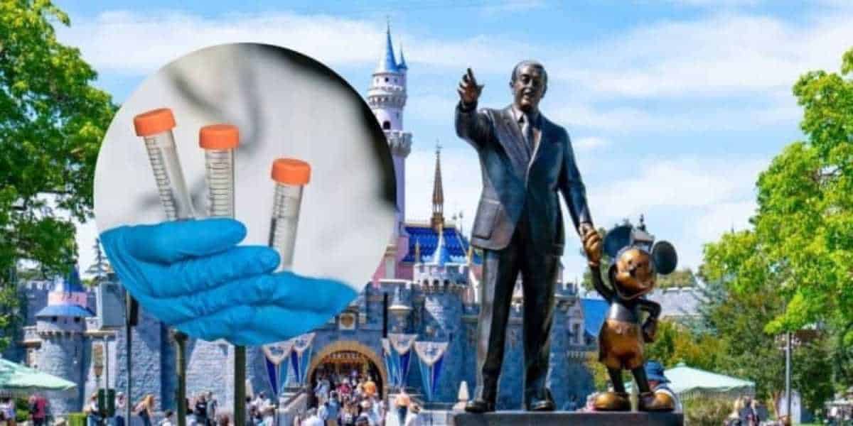A collage image featuring a close-up of gloved hands holding test tubes with orange caps on the left side. The background on the right shows a statue of a man holding the hand of a mouse character, with a castle and a crowd of people in the distance.