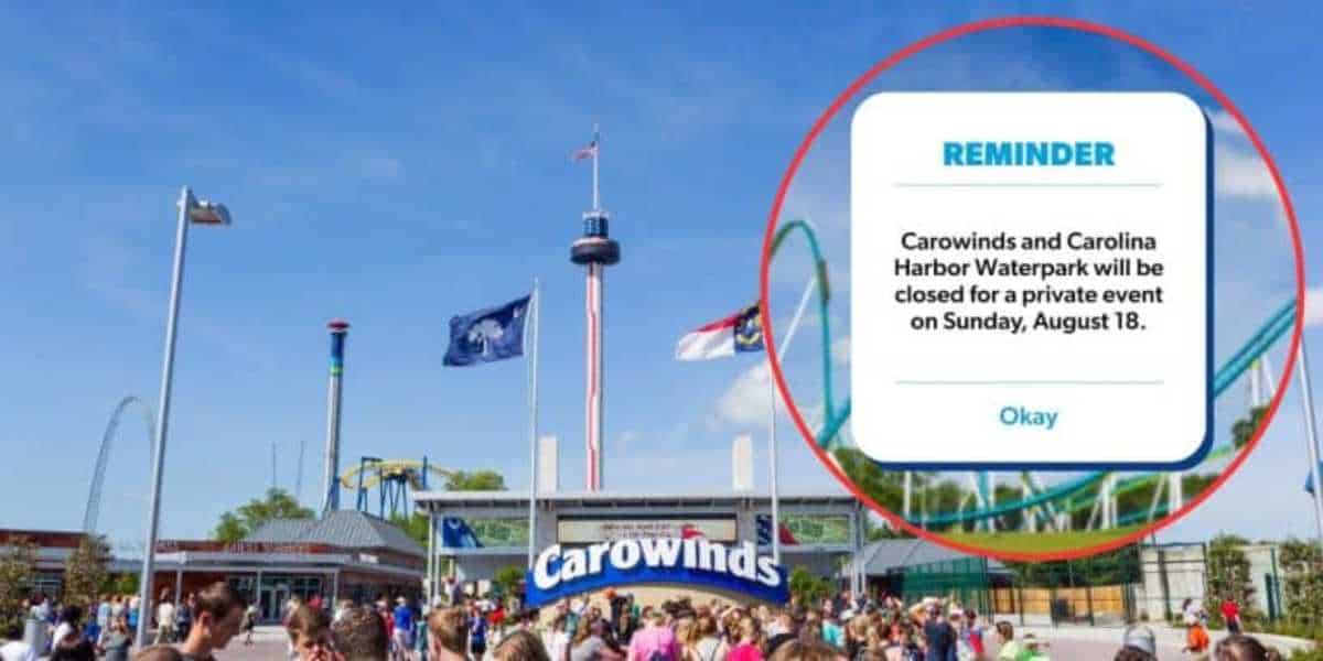 Image of Carowinds amusement park entrance with a large crowd of people gathered outside. There is a pop-up notification that reads: "Reminder: Carowinds and Carolina Harbor Waterpark will be closed for a private event on Sunday, August 18." The sky is clear and blue at this Six Flags theme park.