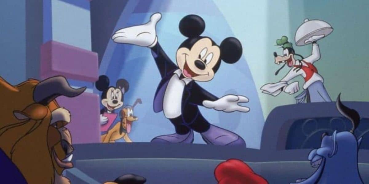 Animated characters, including Mickey Mouse in a tuxedo, pose in a celebratory manner. Goofy is seen holding a tray with a plate, while other familiar Disney characters like Pluto and the Beast from "Beauty and the Beast" appear in the background.