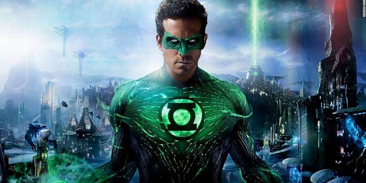 A superhero in a green and black suit with a glowing green emblem on the chest stands confidently in a futuristic cityscape. The background features futuristic buildings and green laser-like beams.