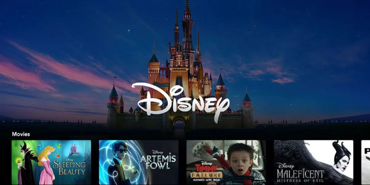 An image of the Disney+ streaming platform interface. At the top is the iconic Disney castle with "Disney" written in white. Below are movie thumbnails, including “Sleeping Beauty,” “Artemis Fowl,” “Timmy Failure,” and “Maleficent: Mistress of Evil.”.