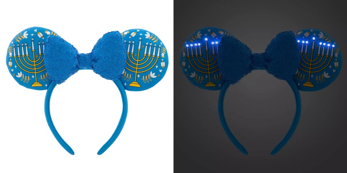 A blue headband with large ears featuring menorah designs on each ear. The headband has a textured blue bow in the center. The image shows the headband in light and dark settings, with the menorahs lit up in the dark.