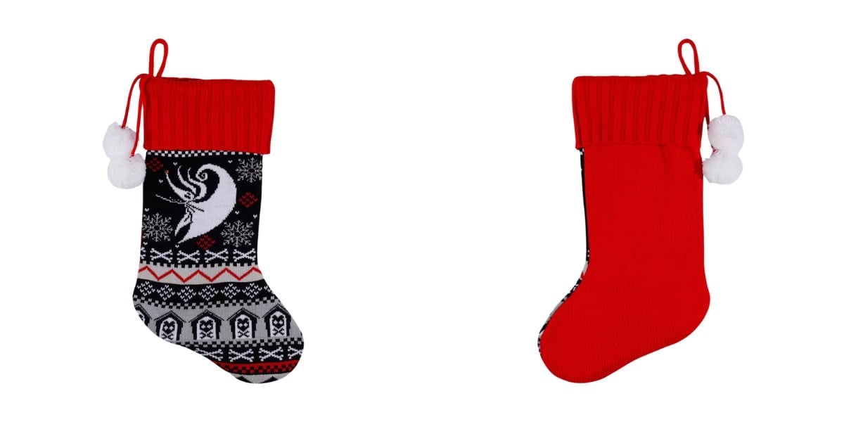 Two Christmas stockings: one black with a white deer and snowflake pattern, and the other solid red. Both have red tops and are adorned with white pom-poms.