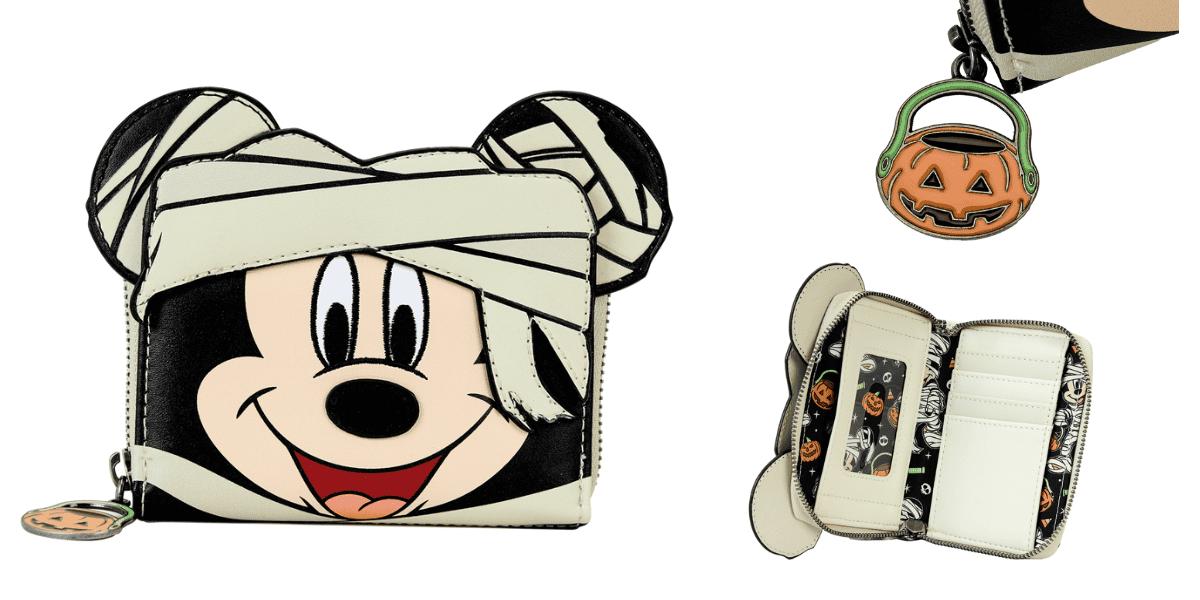 A wallet designed to look like a cartoon character wrapped as a mummy with a smiling face. It includes a pumpkin-shaped keychain attachment. The wallet is open, showing a Halloween-themed interior with slots and compartments.