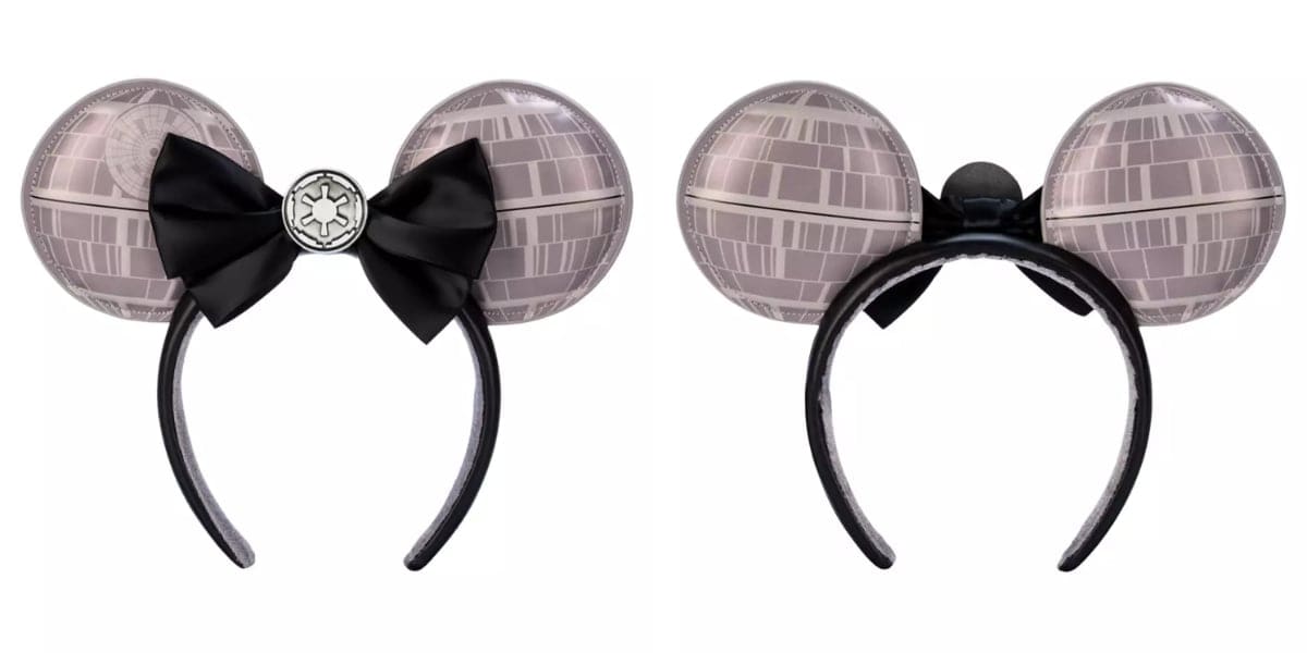 A pair of headbands featuring large spherical designs resembling a futuristic space station. One headband has a black bow with a symbol in the center, while the other is plain. Both have a glossy finish and are set against a white background.