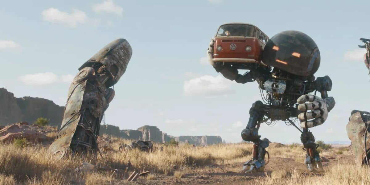 A giant robot carries a VW beetle wagon through a war-torn world.