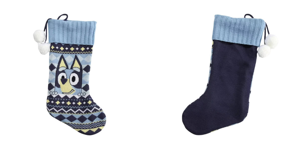 Two Christmas stockings. The first features a cartoon dog and a geometric pattern in blue and yellow. The second is solid dark blue with a light blue cuff. Both have pom-pom accents.