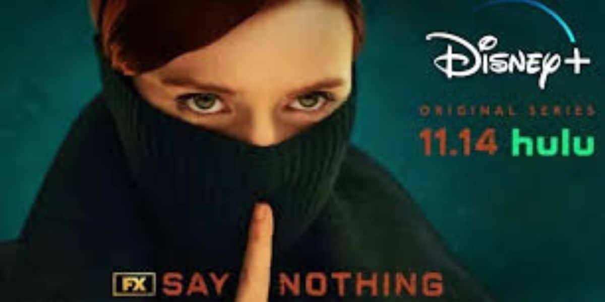 A person with red hair holding a finger to their lips in a shushing gesture, wearing a black turtleneck. The image promotes a Disney+ original series, with "11.14" and "hulu" text in orange and green, along with "FX" and "SAY NOTHING.