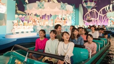 A group of people ride "it's a small world" at Tokyo Disneyland