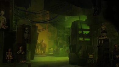 A dimly lit room with eerie green lighting contains several creepy dolls on shelves. Two figures in hazmat suits stand in the background, partially obscured by shadows. The setting appears mysterious and unsettling at Universal Horror Unleashed.