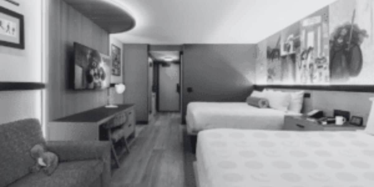 A black and white photo of a double bed hotel room at Disneyland Resort's Pixar Place Hotel.