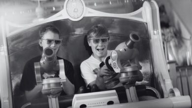 A black and white picture of two people on Toy Story Midway Mania!, a ride at Disneyland Resort.
