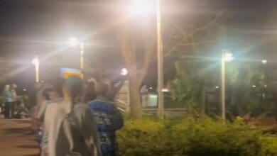 Crowds wait for the Walt Disney World Skyliner in the dark at Disney's Pop Century Resort.
